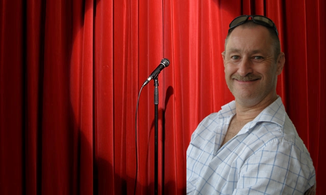 Andy in front of curtain